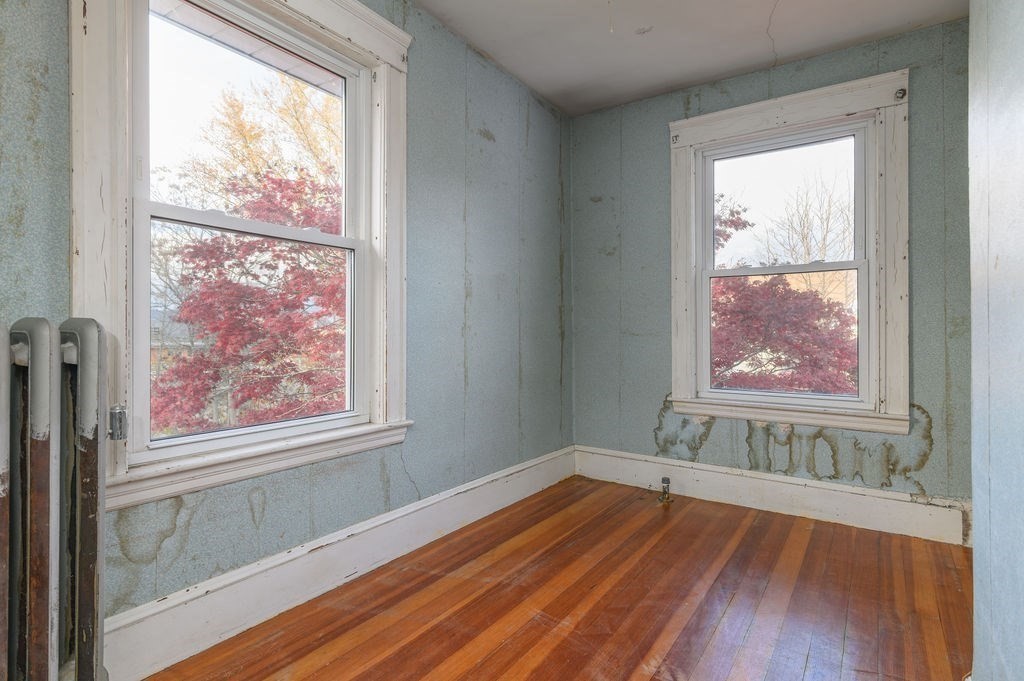 56 Putnam Street Weymouth, MA 02189 - Photo 19 of 39 a view of an empty room with wooden floor and a window