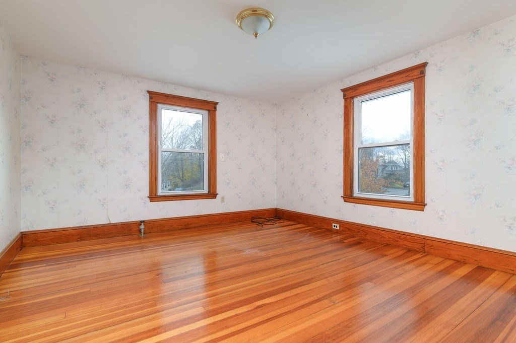 56 Putnam Street Weymouth, MA 02189 - Photo 21 of 39 a view of an empty room with wooden floor and a window