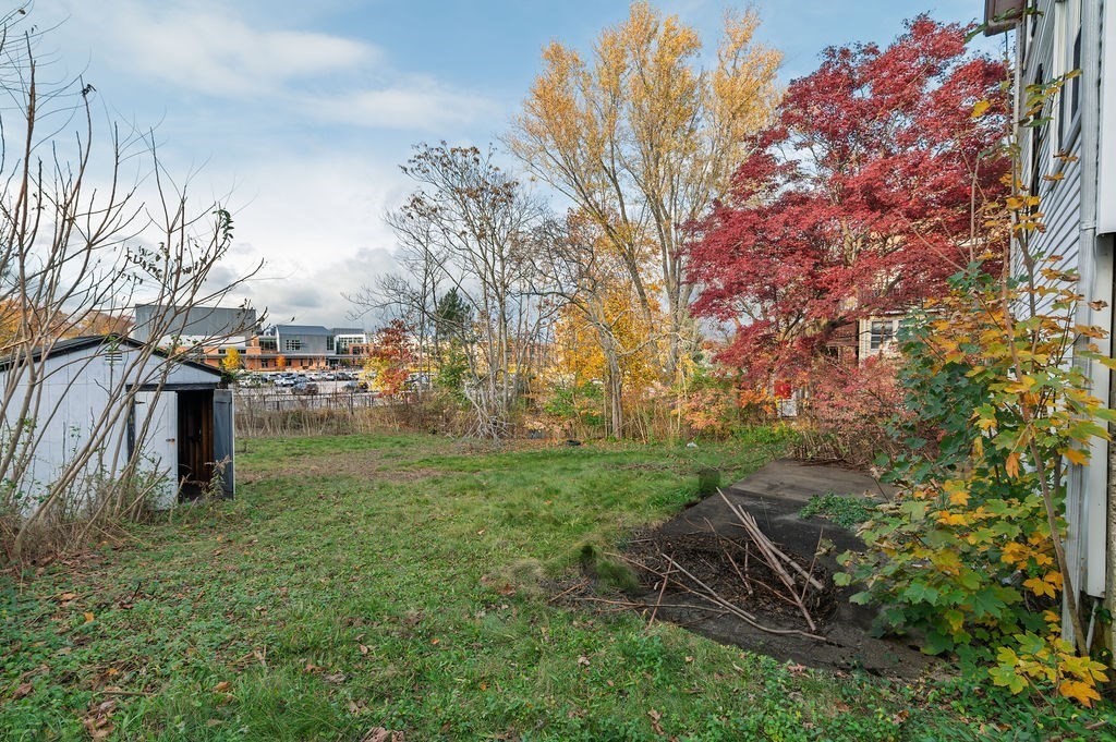 56 Putnam Street Weymouth, MA 02189 - Photo 22 of 39 a backyard of a house with lots of green space