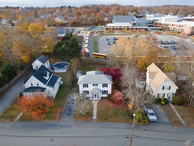 an aerial view of a house with yard swimming pool and ocean view