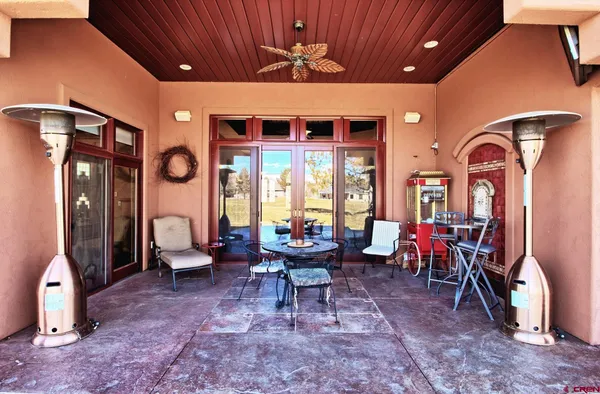 a room with stainless steel appliances lots of counter space and chandelier