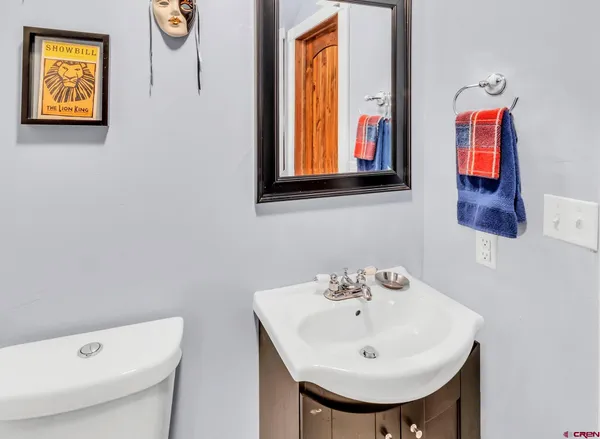 a bathroom with a toilet a sink and a mirror