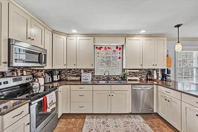 a kitchen with sink stove and cabinets