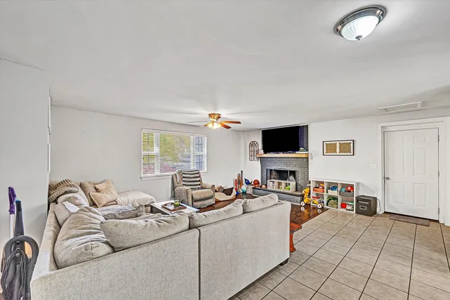a living room with furniture wooden floor and a large window