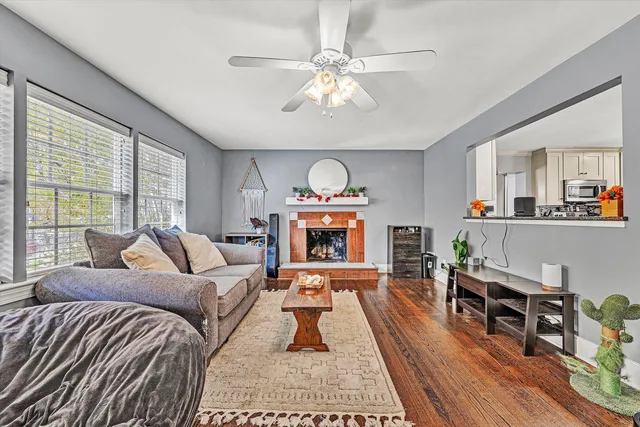 a kitchen with stainless steel appliances granite countertop a dining table chairs and granite counter tops