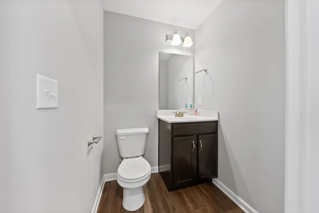 a bathroom with a toilet sink and mirror