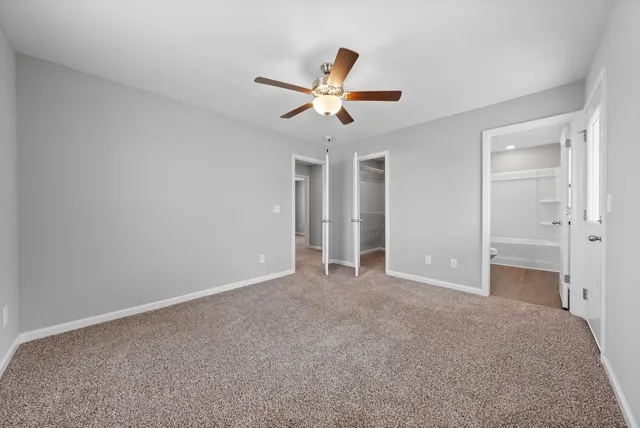 a bathroom with a sink a toilet a window and shower