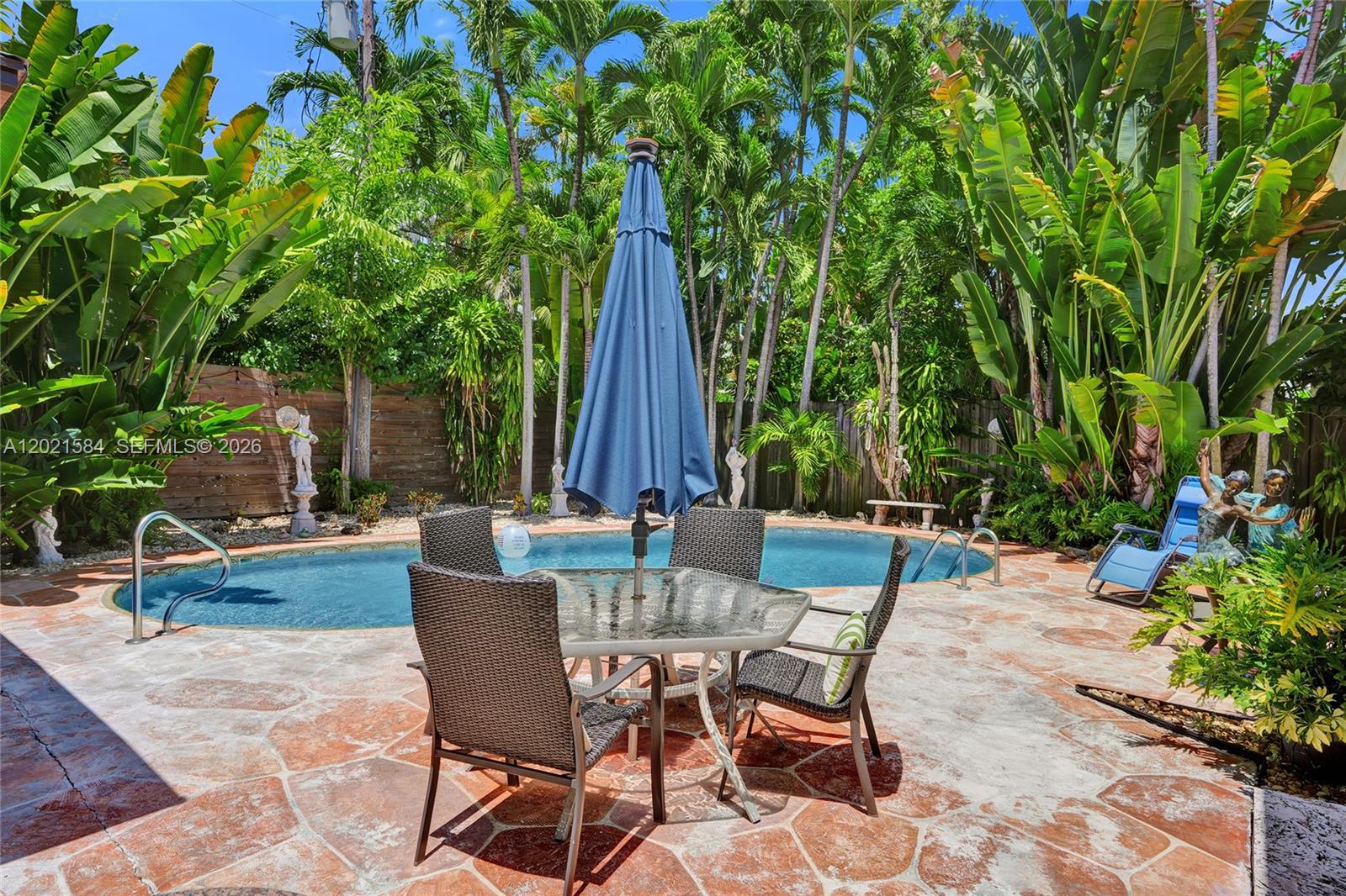 811 Northeast 73rd Street Miami, FL 33138 - Photo 31 of 51 a view of a patio with a table and chairs and potted plants