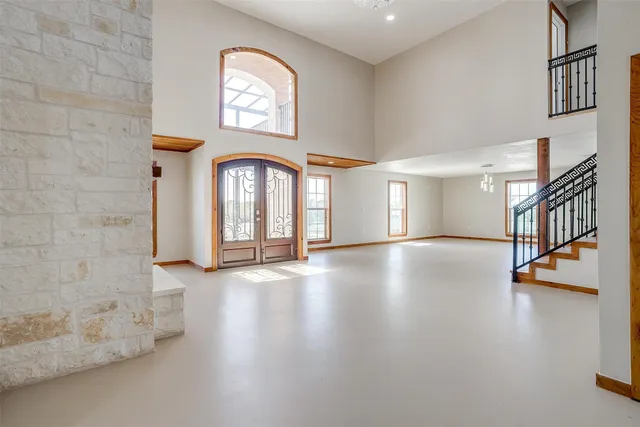a large white kitchen with a large window and stainless steel appliances
