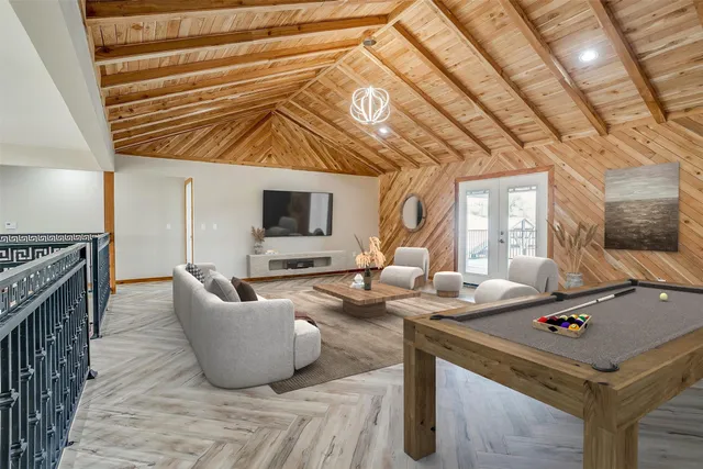 an empty room with wooden floor and ceiling fan