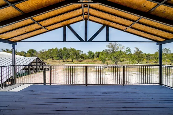 an empty room with wooden floor and ceiling fan