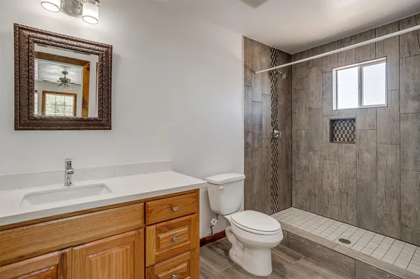 a bathroom with a sink a toilet and a mirror