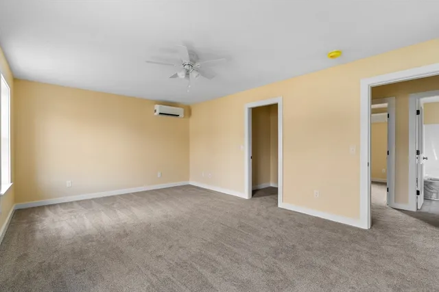 a view of an empty room with a ceiling fan