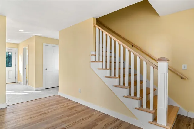 a view of an entryway with wooden floor