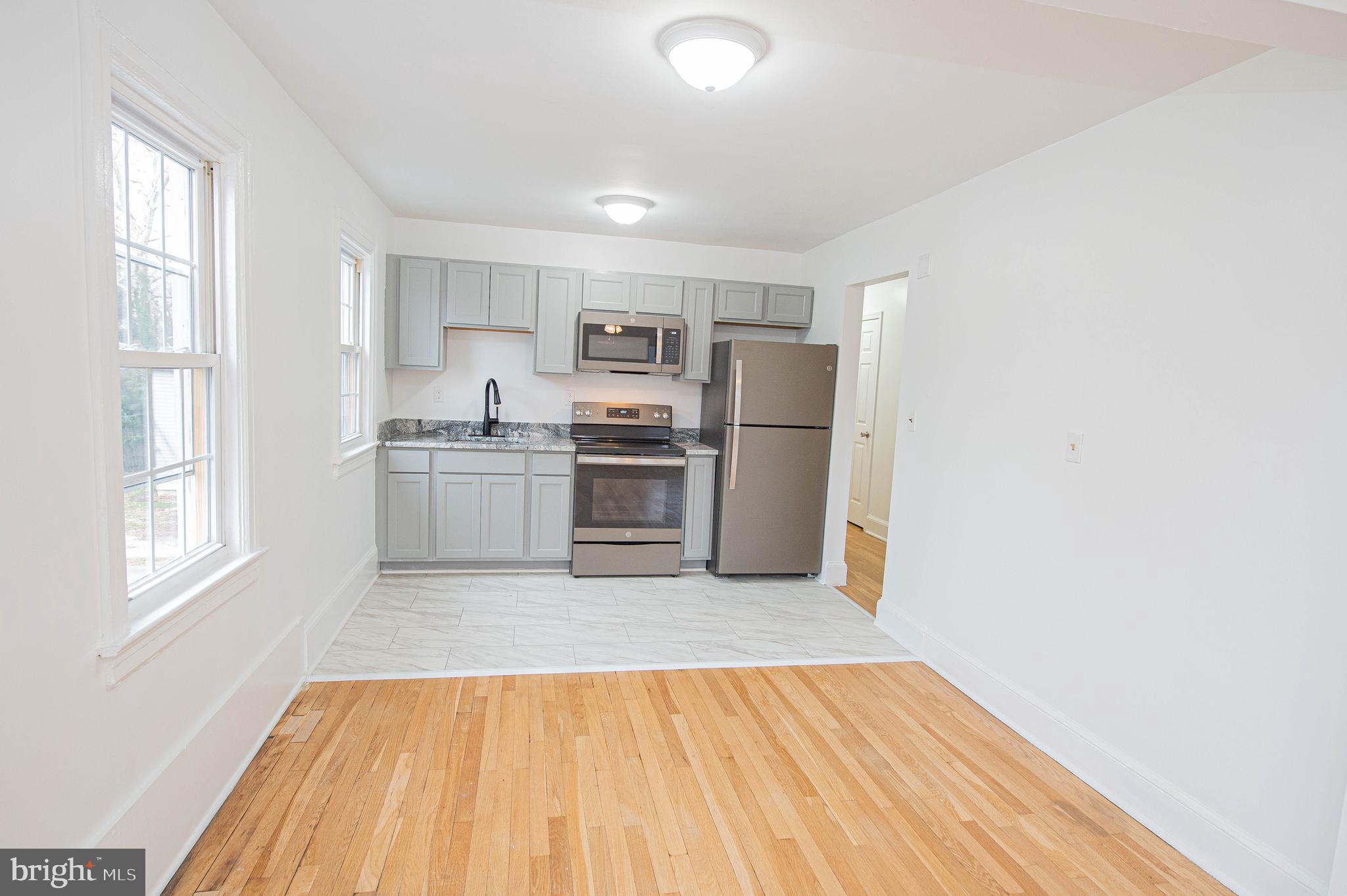 308 North Division Street, Unit 16 Salisbury, MD 21801 - Photo 19 of 61 a view of kitchen with wooden floor electronic appliances and window