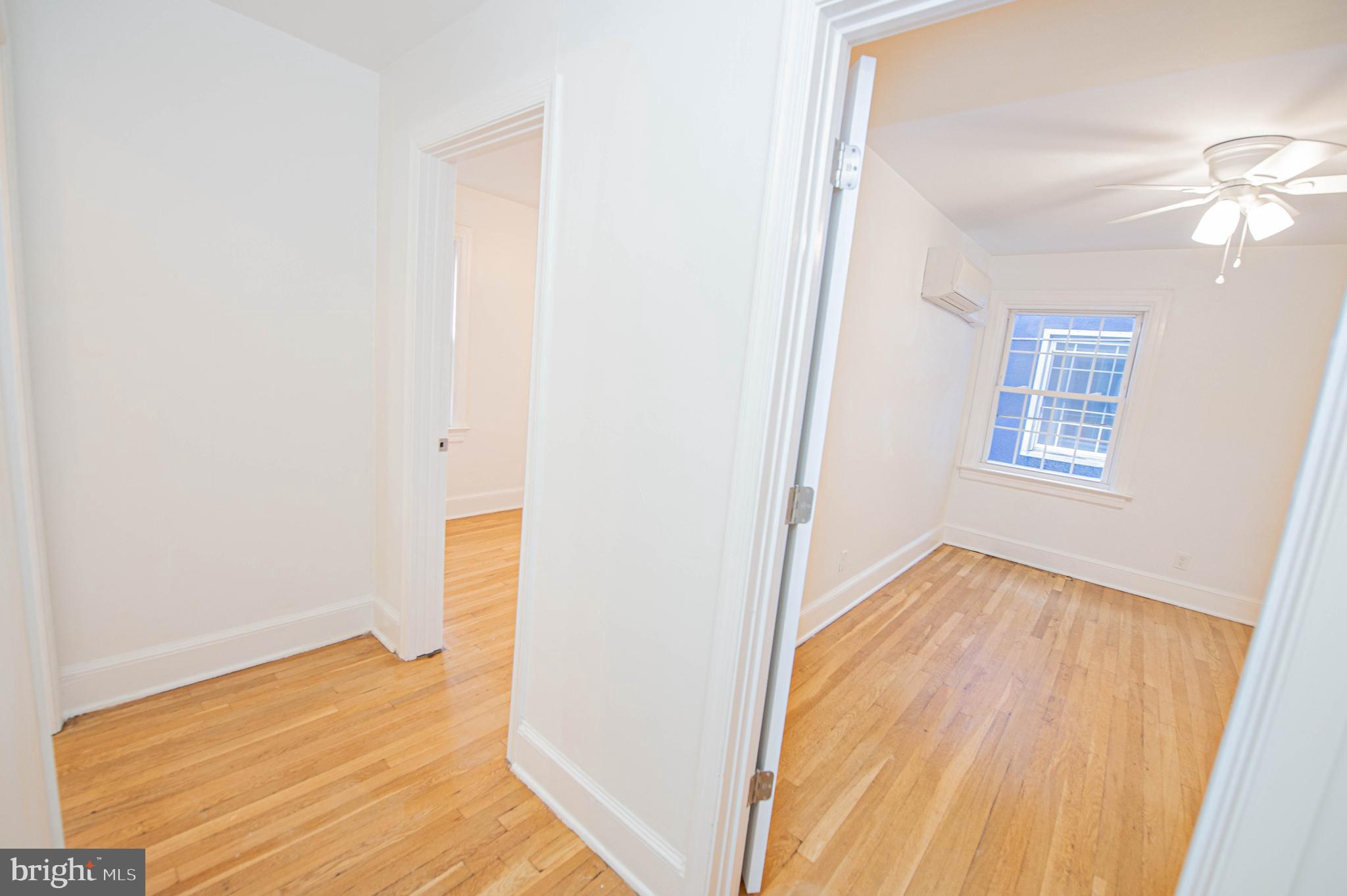 308 North Division Street, Unit 16 Salisbury, MD 21801 - Photo 35 of 61 a view of an empty room with wooden floor and a window