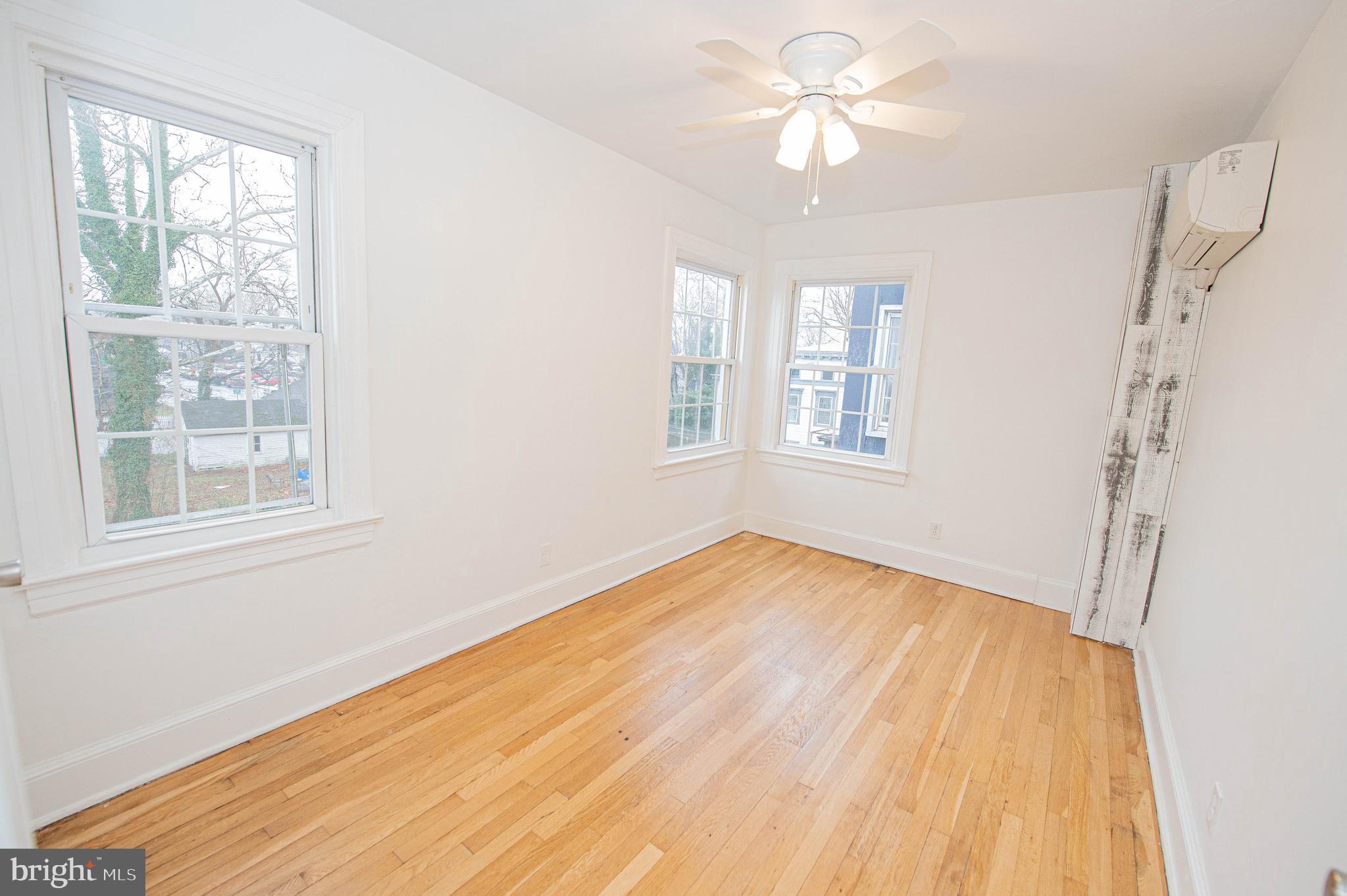 308 North Division Street, Unit 16 Salisbury, MD 21801 - Photo 42 of 61 a view of empty room with wooden floor and fan
