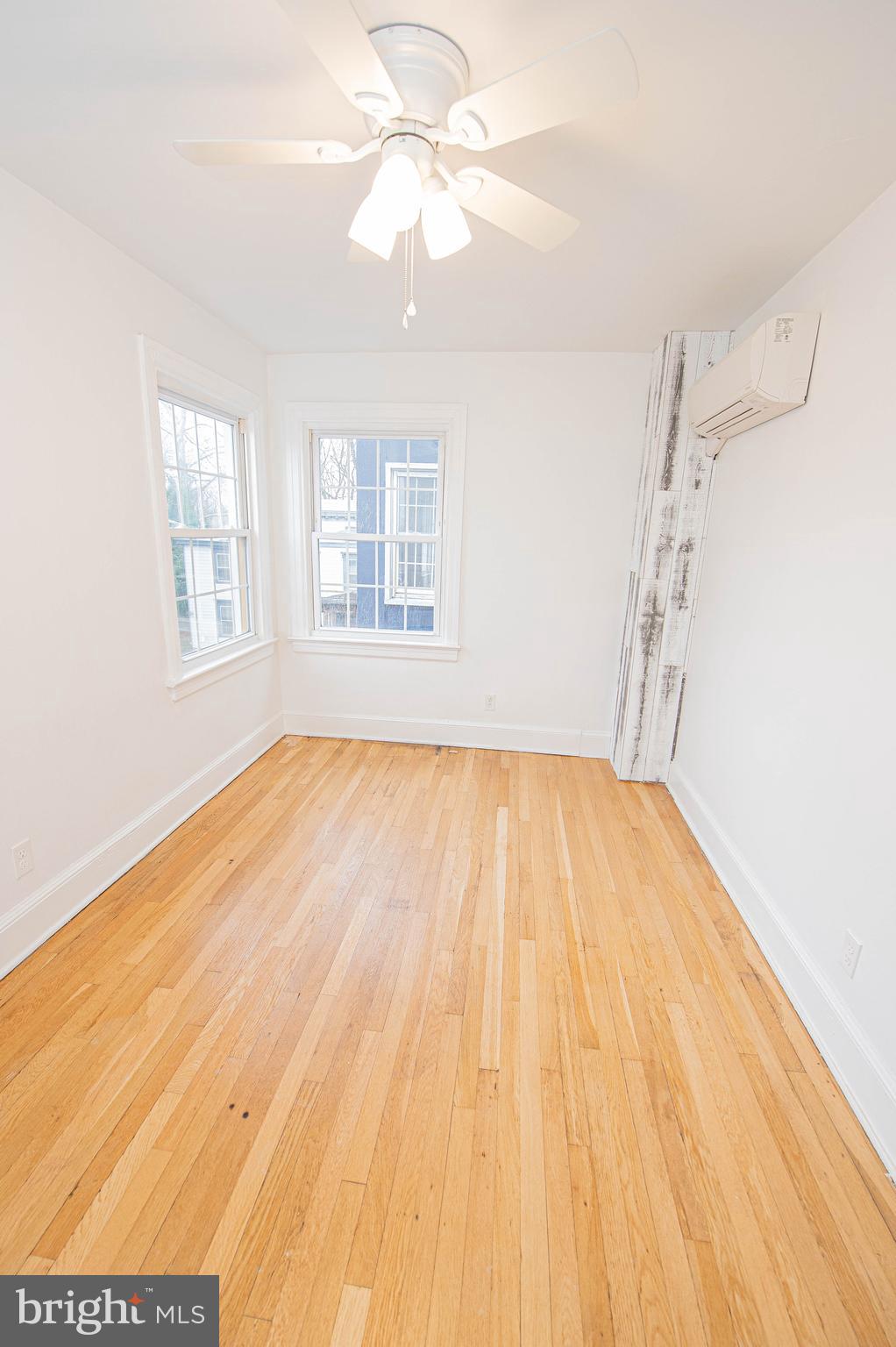 308 North Division Street, Unit 16 Salisbury, MD 21801 - Photo 43 of 61 a view of empty room with wooden floor and fan