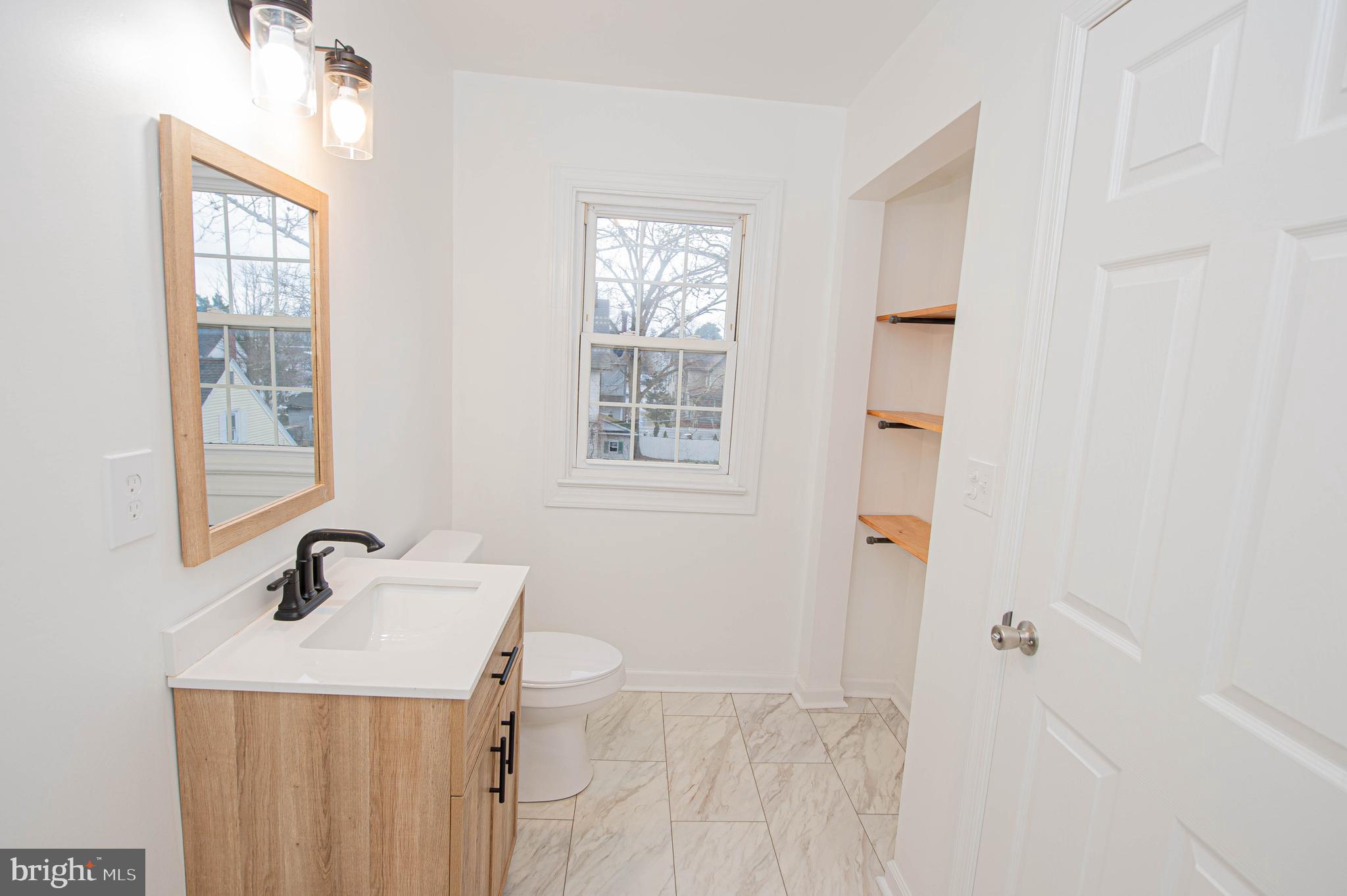 308 North Division Street, Unit 16 Salisbury, MD 21801 - Photo 53 of 61 a bathroom with a sink a mirror and shower