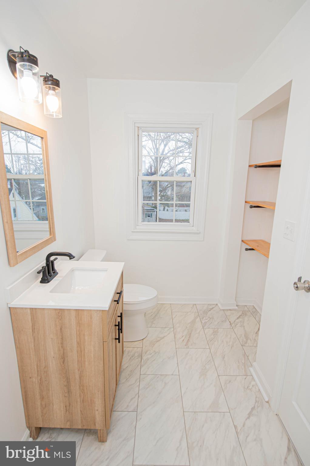 308 North Division Street, Unit 16 Salisbury, MD 21801 - Photo 54 of 61 a bathroom with a sink a vanity and a mirror