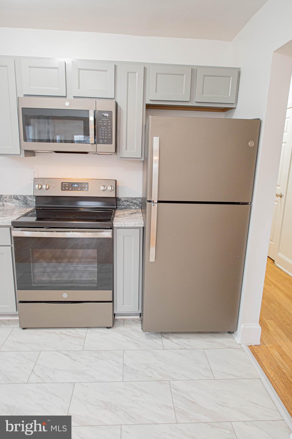 308 North Division Street, Unit 16 Salisbury, MD 21801 - Photo 59 of 61 a white refrigerator freezer and a stove sitting inside of a kitchen