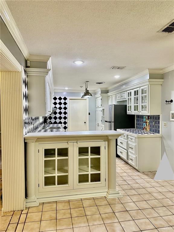 1518 Redbud Avenue McAllen, TX 78504 - Photo 15 of 39 a open kitchen with white cabinets a stove and a window