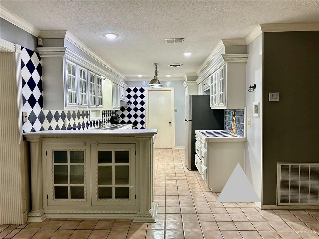 1518 Redbud Avenue McAllen, TX 78504 - Photo 16 of 39 a kitchen with stainless steel appliances kitchen island granite countertop a refrigerator and a stove