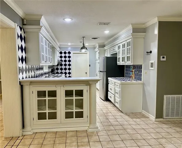 a kitchen with a refrigerator and a sink