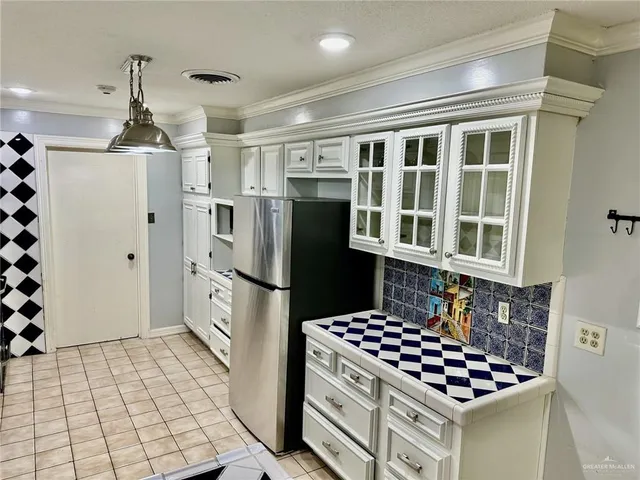 an empty room with wooden floor closet and windows
