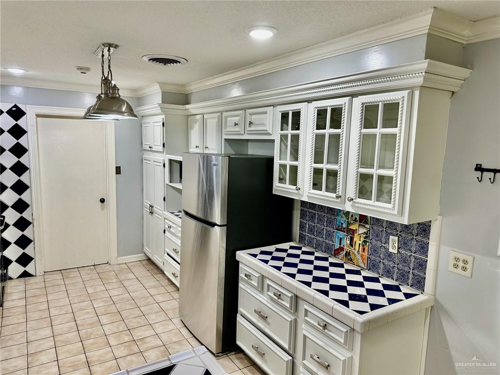 1518 Redbud Avenue McAllen, TX 78504 - Photo 17 of 39 a kitchen with stainless steel appliances granite countertop a refrigerator and a stove top oven