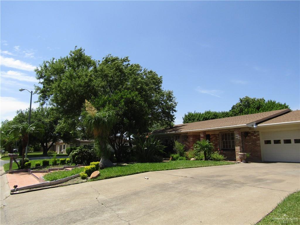 1518 Redbud Avenue McAllen, TX 78504 - Photo 3 of 39 a view of a house with a garden and pathway