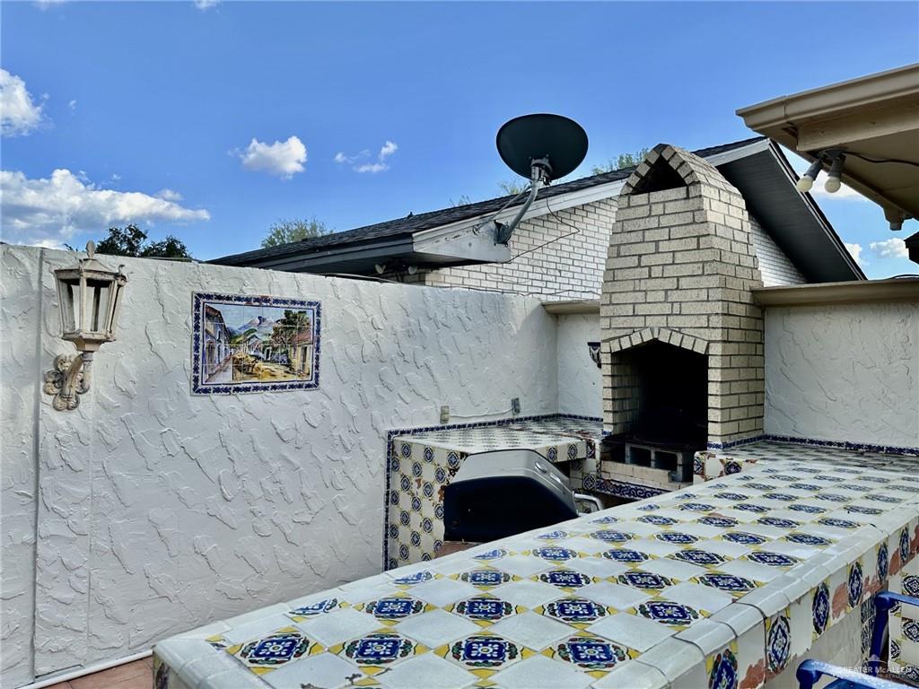 1518 Redbud Avenue McAllen, TX 78504 - Photo 32 of 39 a bedroom with a bed and a fireplace