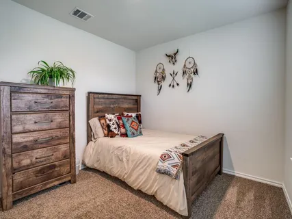 a bedroom with a bed and a painting on the wall