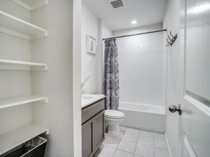 a bathroom with a shower a bathtub and toilet