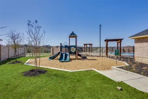 a view of a house with backyard and a slide