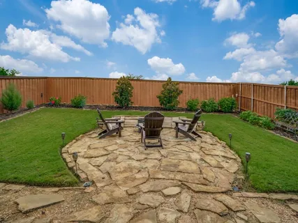 a view of a patio with table and chairs and potted plants