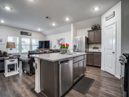 a kitchen with stainless steel appliances granite countertop a stove and refrigerator