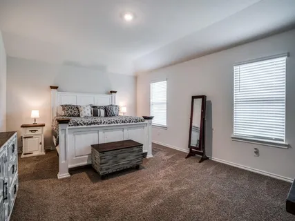 a kitchen with a refrigerator and white cabinets