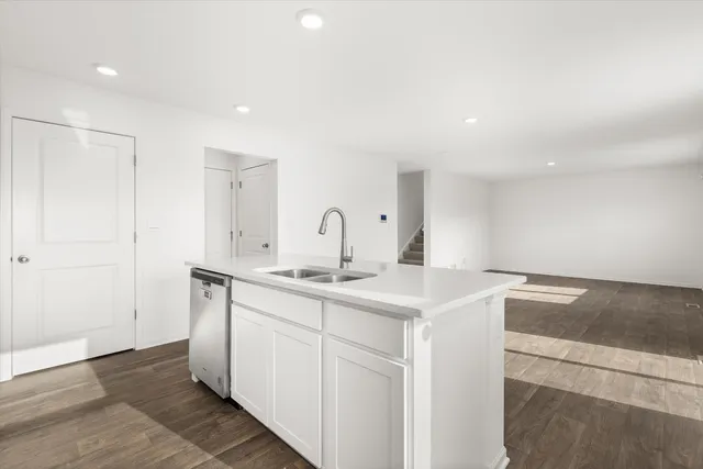 a kitchen with a sink and a refrigerator