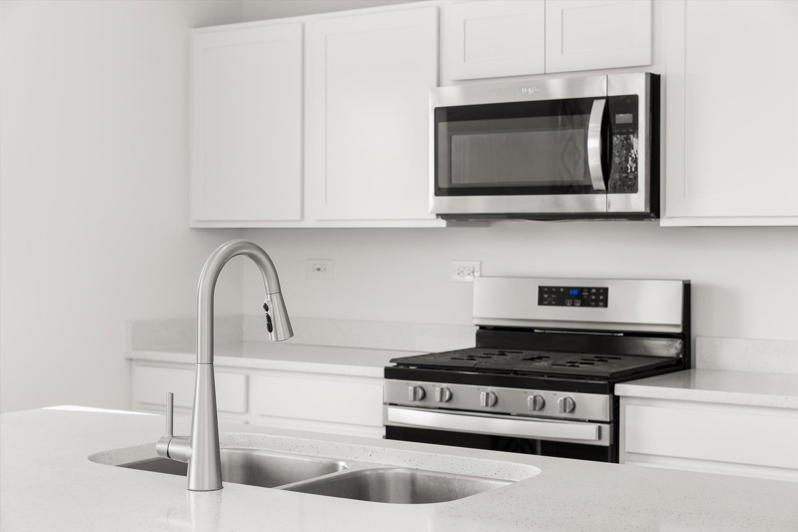6616 Hadrian Drive Joliet, IL 60431 - Photo 16 of 47 a kitchen with stainless steel appliances granite countertop a sink a microwave and cabinets