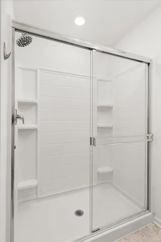 a bathroom with a glass shower door