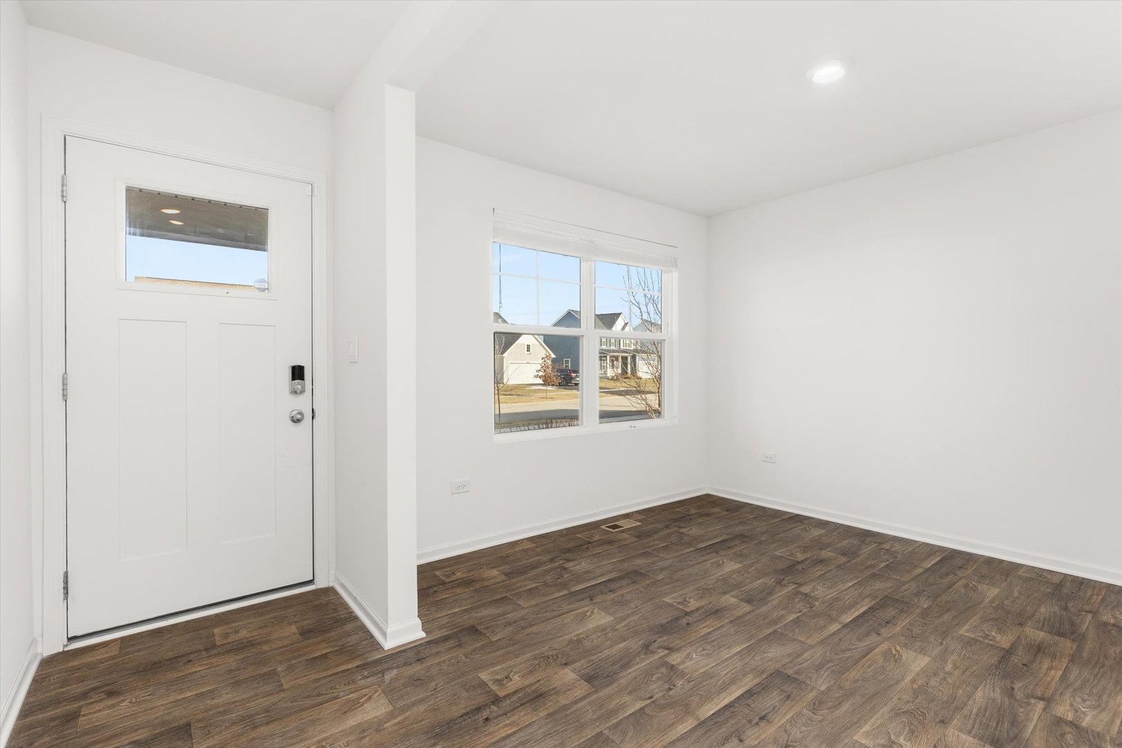6616 Hadrian Drive Joliet, IL 60431 - Photo 3 of 47 an empty room with wooden floor and windows