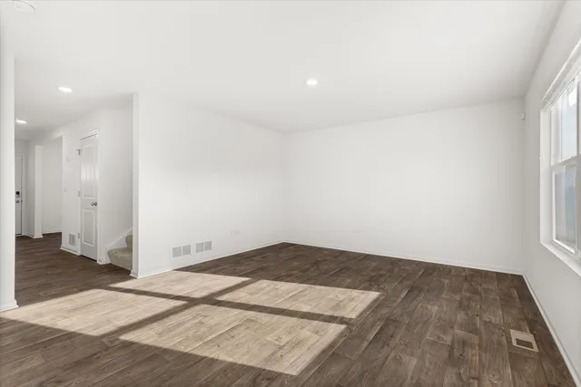 an empty room with wooden floor