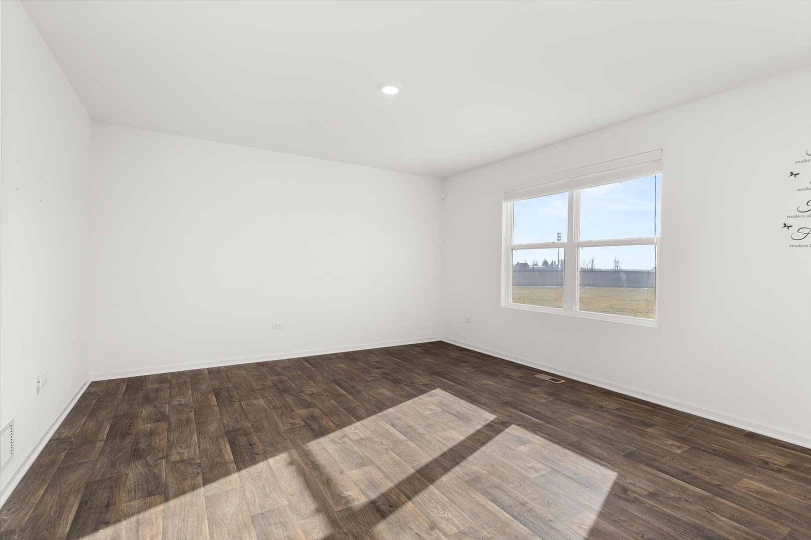 6616 Hadrian Drive Joliet, IL 60431 - Photo 8 of 47 an empty room with wooden floor and windows
