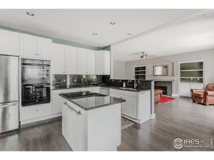 a kitchen with white cabinets sink and stainless steel appliances