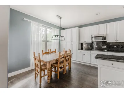 a kitchen with granite countertop a sink stove and refrigerator