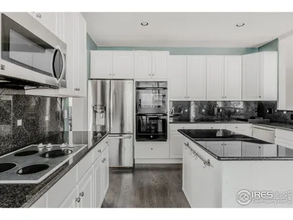 a kitchen with stainless steel appliances granite countertop a lot of counter space and a sink