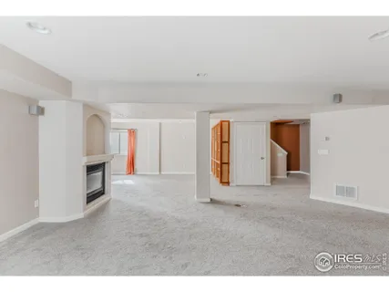 a view of empty room with a fireplace