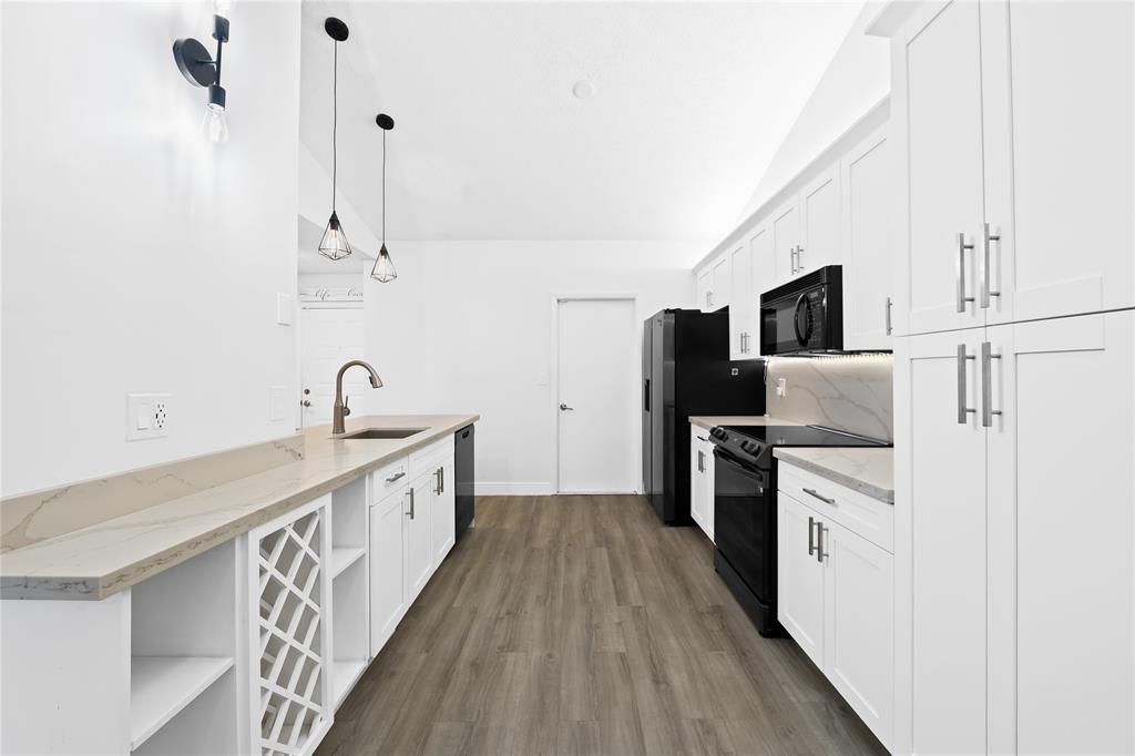 8245 Northwest 70th Street Tamarac, FL 33321 - Photo 1 of 29 a kitchen with stainless steel appliances a white cabinets and sink