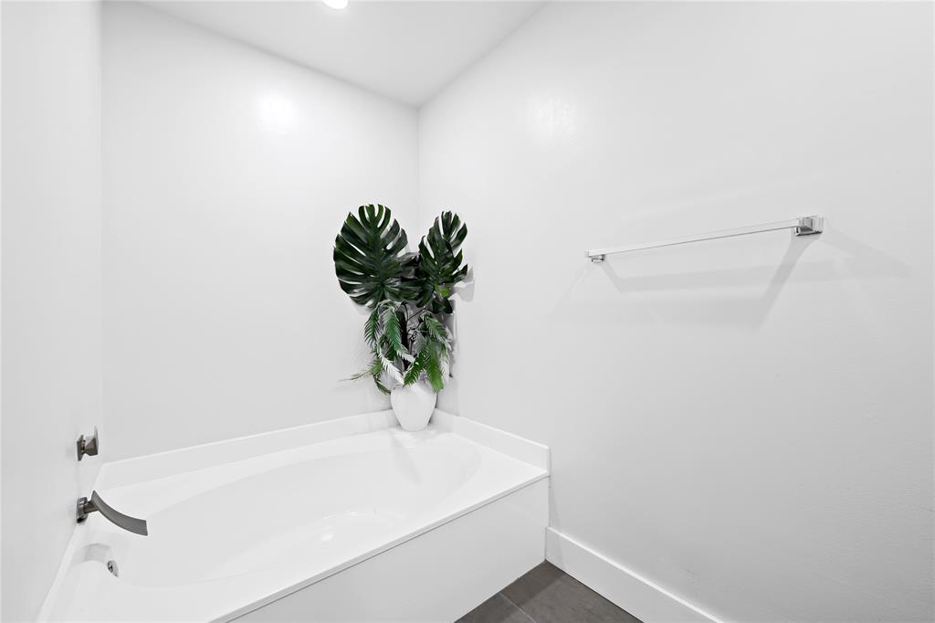 8245 Northwest 70th Street Tamarac, FL 33321 - Photo 11 of 29 a white bath tub sitting in a bathroom